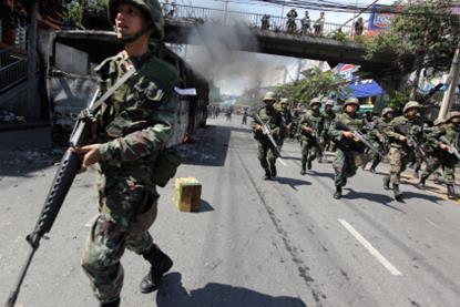 Members of the Thai military take over the streets as gun battles break out during violent protests on April 13, 2009 in Bangkok, Thailand. Anti-government protesters clashed with the military on the streets of Thailand's capital after the government decl